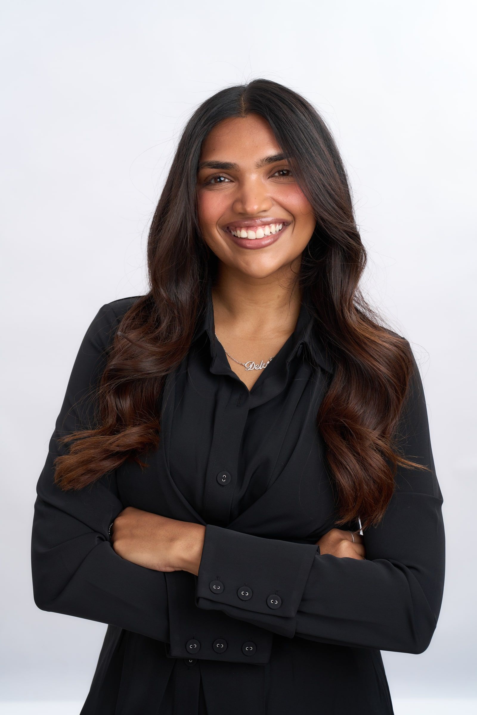 Delcy Pandya in a black blazer, arms crossed